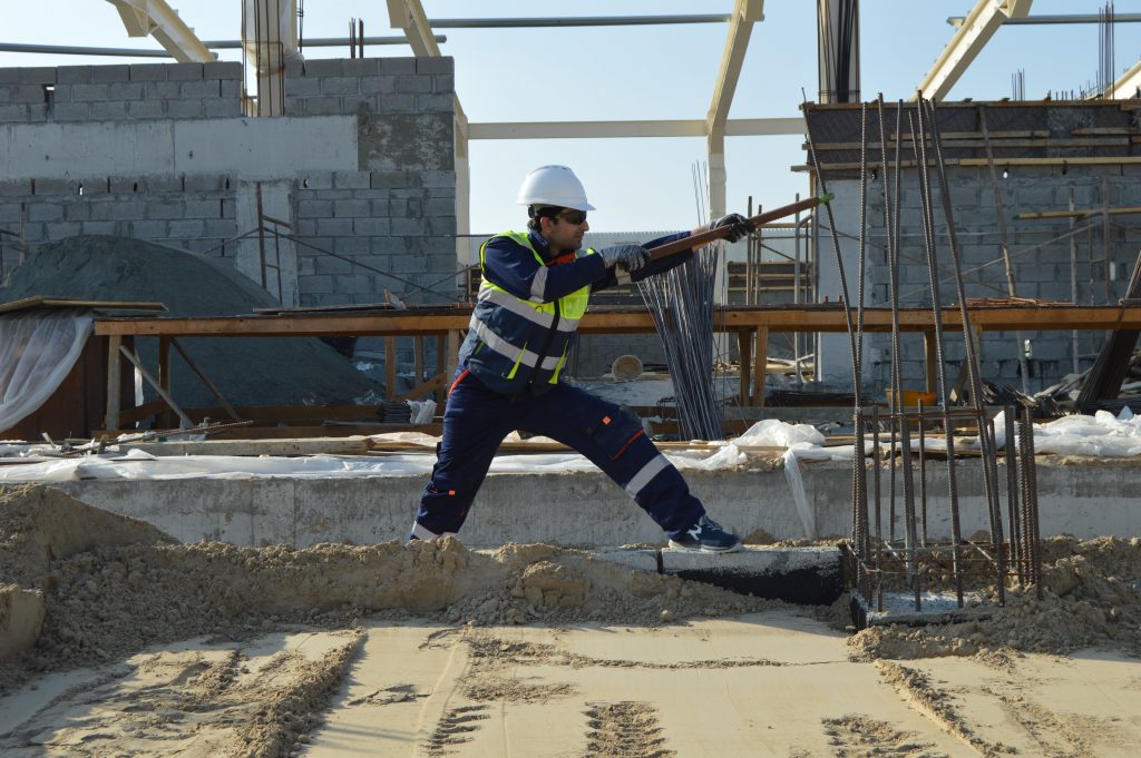Builder in action on site